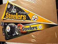 Two Steelers felt pennants on cardboard backing