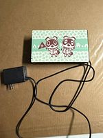 Front of Animal Crossing edition Switch dock sitting on brown surface