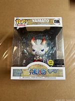 Front of boxed Funko Pop! Deluxe Yamato figure showing character, number 1596, glow-in-the-dark and exclusive stickers
