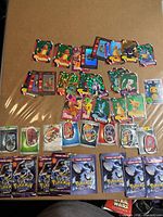 Overview of all loose cards and sealed dog tag packs laid out on cardboard surface