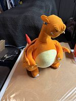 Front view of Charizard plush standing upright