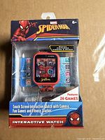 Front view of boxed Spiderman interactive watch