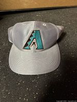 Front view of cap showing embroidered Diamondbacks logo and bill