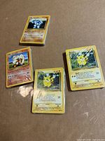 front view of four shrink-wrapped bundles showing Pikachu, Ninetales and other cards