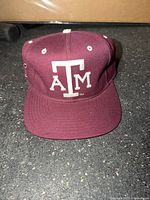 Front view showing ATM logo and brim