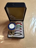 Overall view of watch in box with extra bezels