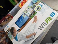 Front of Wii Fit U boxed bundle showing software and fitness imagery