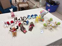 Full group of felted animal figurines on table