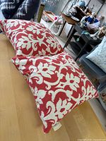 Two patterned square pillows on table
