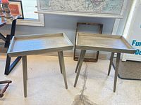 Both matching tray-top side tables front view