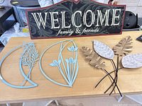 All four wall décor pieces on table