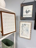 Group shot showing all three framed prints on wall shelving