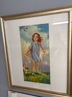 Framed print of girl in blue dress with butterfly, flowers and doll carriage