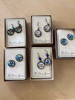 Overview of five boxed earring pairs