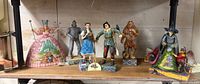 Group shot of six Jim Shore Wizard of Oz figurines on shelf