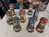 Group of nine porcelain lighthouse ornaments on tray