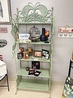 Front view of full green wrought iron etagere with five shelves