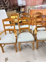 front view of six chairs including two armchairs
