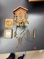 Clock front with carved figures and accessories laid out