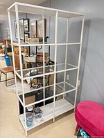 front view of white metal and glass shelving unit