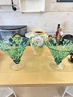 Front view of ceramic vase and two glass bowls on table