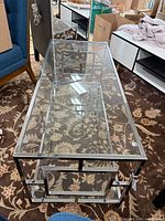 full view of glass top coffee table on rug
