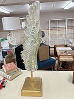 Full view of wing sculpture on stand