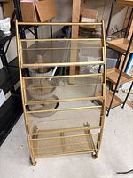 Front view of gold metal mesh card display rack