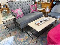 Full living room setup showing coffee table and two side tables with décor items on top