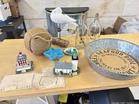 Group shot of nautical items excluding whale tail vase