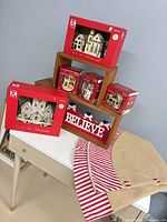 Group shot showing both LED villages, three secret buildings, Believe sign, tree skirt