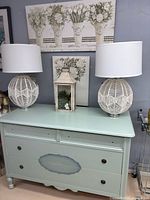 Both macramé table lamps on dresser showing overall design and shades