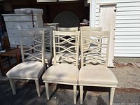 Four lattice-back chairs showing design and seat condition