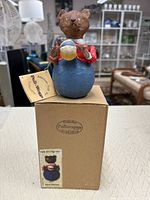 Bear figurine on top of original box with hang tag visible