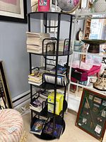 Full view of rotating round bookshelf holding books, four tiers visible