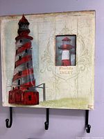 Lighthouse wall décor with hooks and photo frame