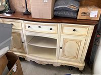 Front view of Thomasville buffet showing drawers, doors, open shelf, dark top