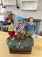 Front view of animated musical Three Stooges golf figurine showing characters and base