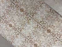 Close-up of fabric pattern beige with brown scrolls