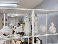 Shelf view showing all five white ceramic items