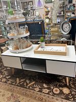 Coffee table front view showing drawers, cubby, legs