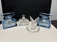 Full lot showing two blue art deco bottles, Lalique Deux Fleurs bottle, Lalique dove ring holder