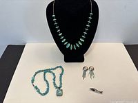 All four jewelry pieces displayed