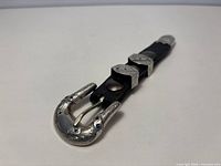 Entire buckle set mounted on black leather strip