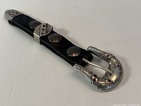 Full view of buckle, keeper and tip assembled on leather strip