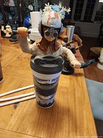 Anakin Skywalker figure topper mounted on cup with straw holes visible