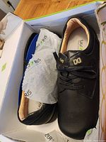 pair of black Savoris shoes in box with tissue paper