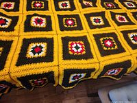 Full view of crocheted afghan covering table, shows colour pattern and size coverage