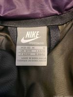 Nike Sportswear size tag showing medium sizing and manufacturing details