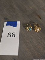 Two 14K gold rings, opal and green stone